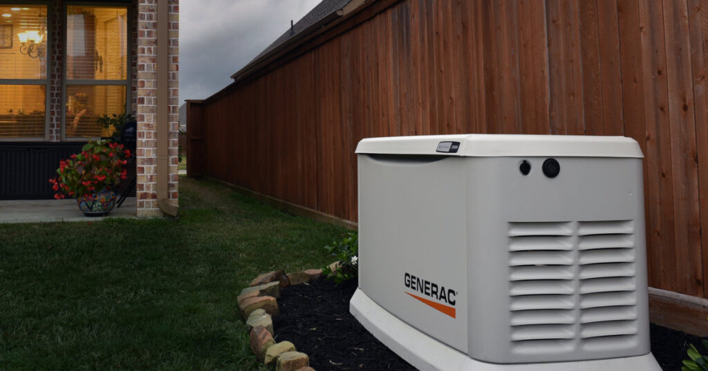 Generac Guardian Generator Backyard Installation Along a High Wooden Fence