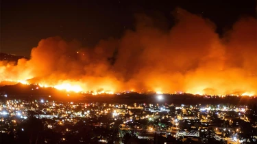 A wildfire rages out of control as it approaches a community in California